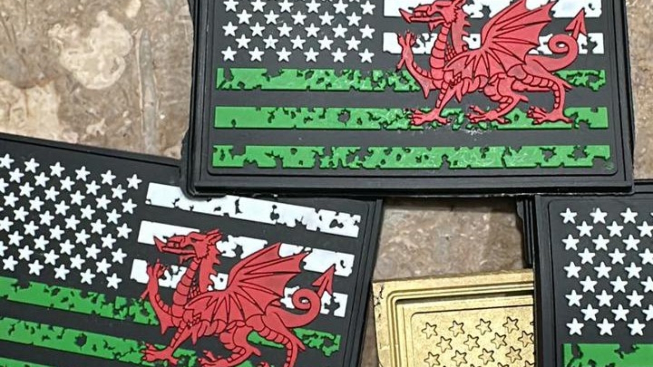 A collection of patches featuring a flag design with green stripes and a red dragon overlay