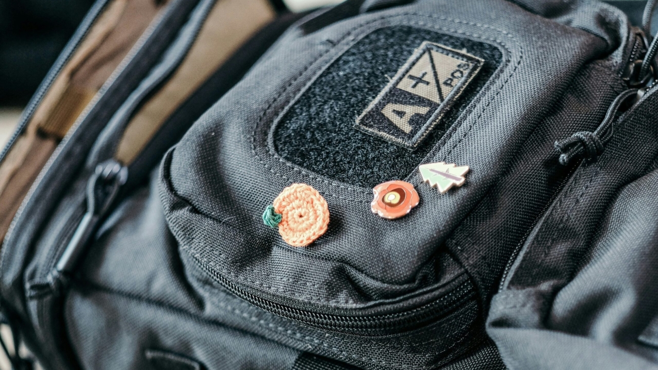 A close-up image of a black backpack featuring a fabric patch