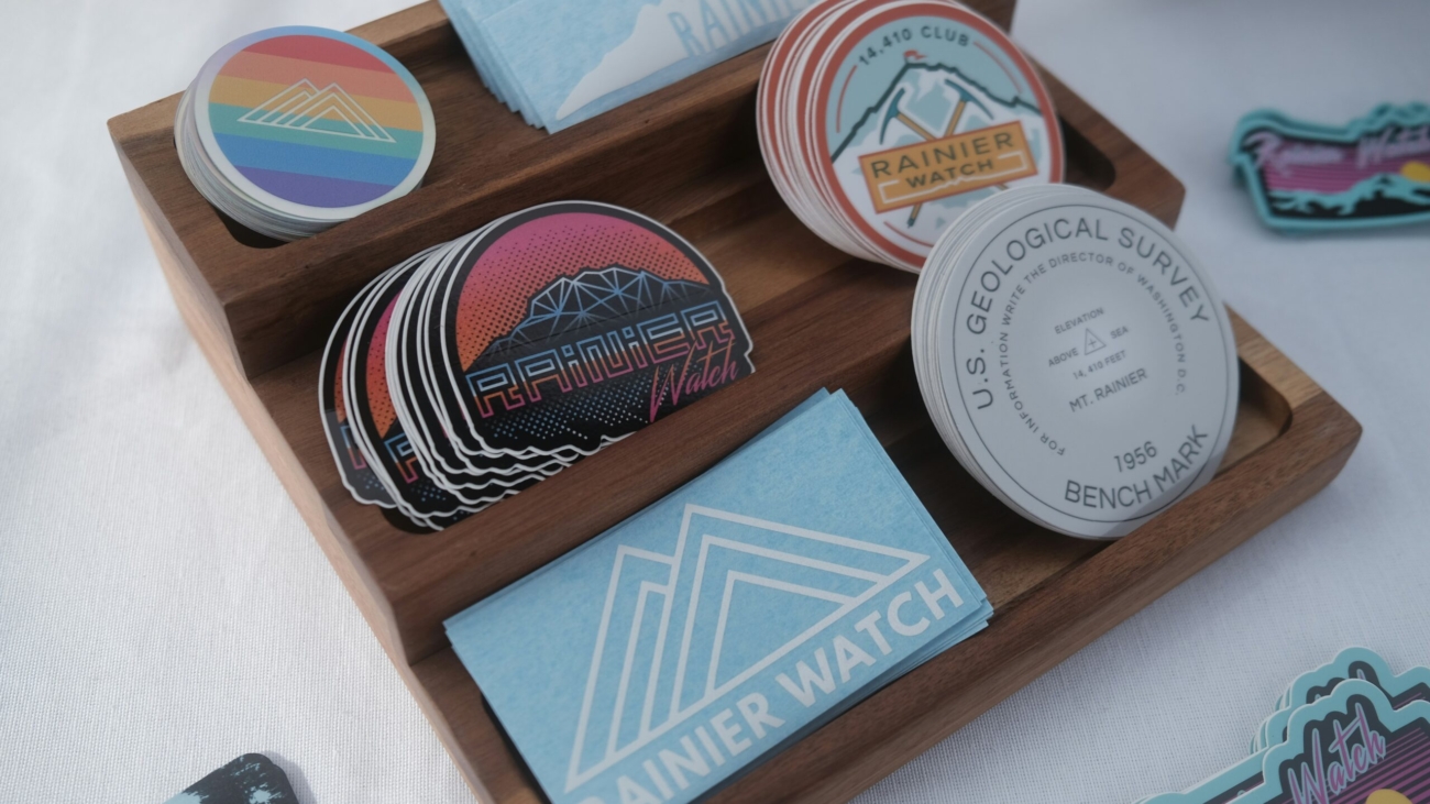 A wooden display tray featuring an assortment of colorful patches